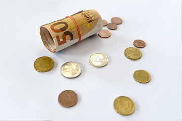 Euro coins lie on the table. European currency on a white background. Various denominations of euro.