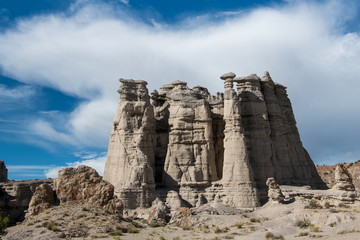 White storm cloud  and blue sky above a rock formation in Plaza Blanca near Abiquiu, New Mexico