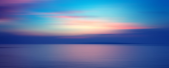 Motion blurred background of sunset on the sea