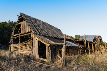 Ruins of an old wooden barn made from rustic logs and planks © Jim Ekstrand