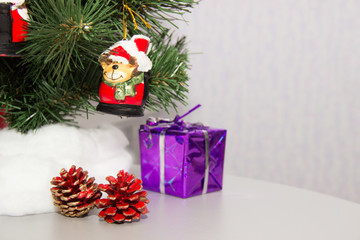 Christmas tree with toys, cones and gift. Close-up