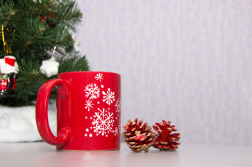 Christmas mug cup with cones standing on the table
