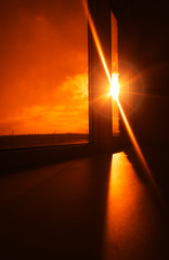 Dramatic sun flare through office window background