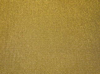 golden background, bright texture. fabric to pack up the Christmas gifts.