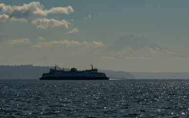 Fototapeta na wymiar Washington State Ferry transiting to Seattle with Mt Rainier in the distance
