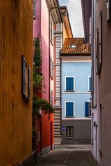 Colorful houses lined along a picturesque cobbled alley in Locarno old town, Canton Ticino, Switzerland