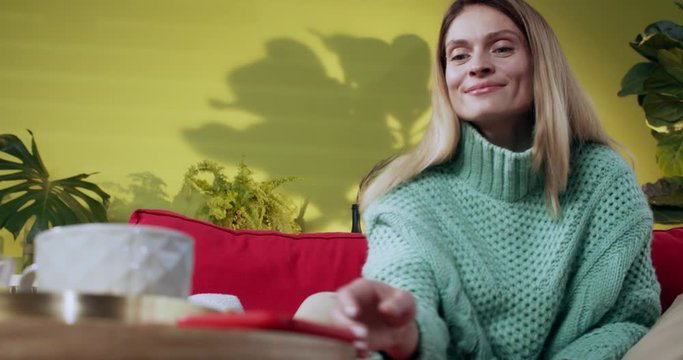 Excited candid woman waiting for phone call looking happy on smartphone answering having pleasant coversation with boyfriend. Casual people lifestyle.