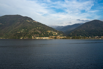 Landscape of Lago Maggiore at sunset from a ferry boat cruising on the lake, Italy