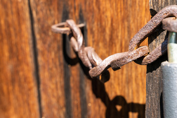 A rusty old chain on a door wood security brown landscape
