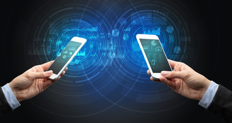 Close up of two smartphones syncing business data