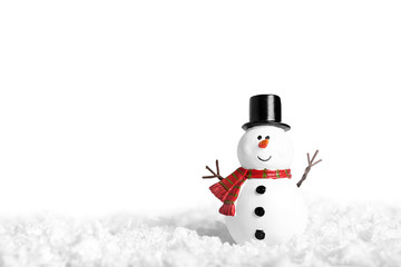 Toy of snowman on snow over white background