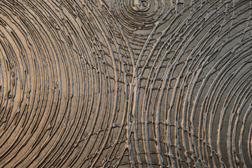 Abstraction, metal surface with circular striped patterns of paint. Gray metallic color. Textured surface with abstract semicircles, backdrop texture