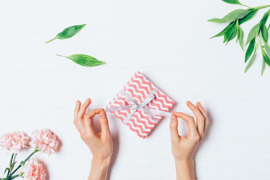 Woman's Hands Unwrapping Small Gift Box