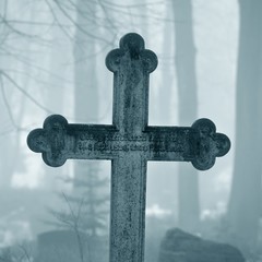 cross in fog at the cemetery