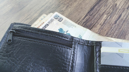 Black wallet with argentinian money