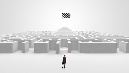 Man standing in front of a big round maze with pirate flag in the center