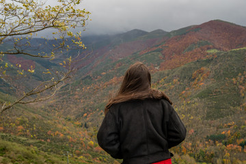young girl enjoying the autumn landscape