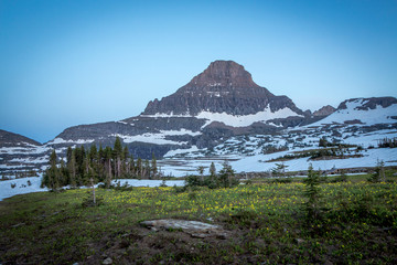 Naklejka premium Peaceful mountain meadow under lonely mountain peak. Beautiful mountain landscape.