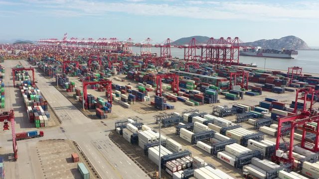 China economy and industry - low angle aerial view of colorful containers stacked in deepsea Port of Shanghai at Yangshan island