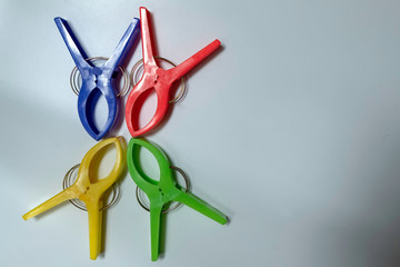 Four large cloth clamps in various colors on a white background.