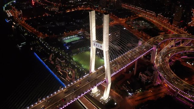 Aerial drone 4k video scene of traffic on Nanpu Spiral road at night, Nanpu bridge, Huangpu River,  Shanghai, China