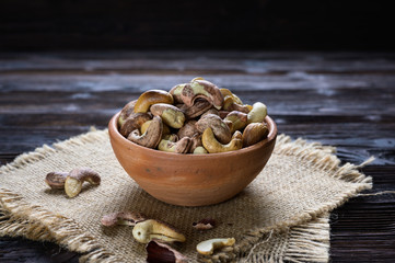 Roasted cashews on natural wooden table background