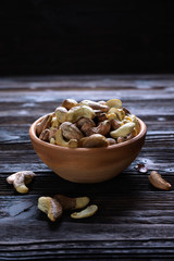Roasted cashews on natural wooden table background