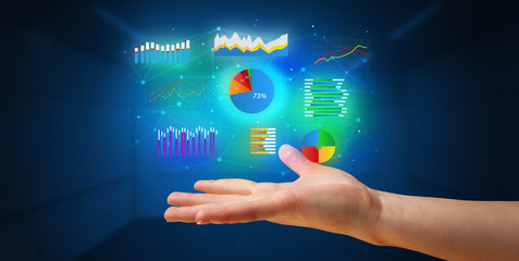 Hand holding diagrams and resultus in his hand, profitable business concept
