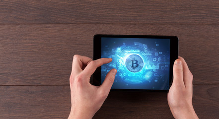 Hand working on tablet with cryptocurrency and network concept