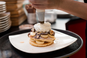 pancakes with chocolate sauce in white dish