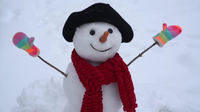 Snowman and winter. Happy smiling snow man on sunny winter day. Cute snowman outdoor. Greeting snowman.