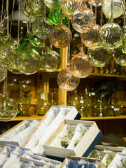 Czech crystal vendor selling glass ornaments at christmas market in Prague, Czech Republic