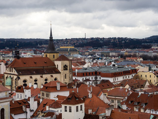 Fototapeta na wymiar Panoramic view of Prague Old Town rooftops on a gloomy winter day - view from Old Town Hall Tower