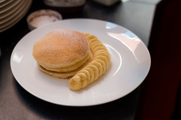 pancakes with banana on white dish