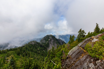 Beautiful View of Canadian Mountain Landscape during a cloudy summer morning. Taken on Crown Mountain, North Vancouver, British Columbia, Canada.