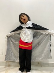 Portrait of a Young Boy Child in a Vampire Costume that is Modeling and Acting in the Studio, as if he is Hunting and Attacking a Fresh Victim