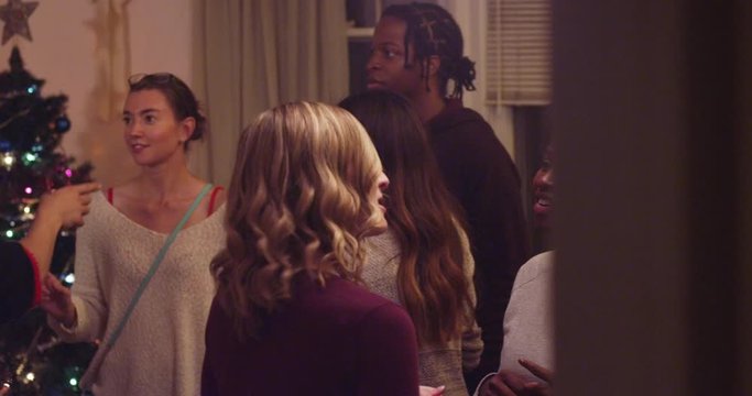 Slow motion panning shot of young adults at a holiday party - shot on RED