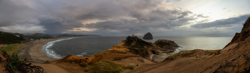 Cape Kiwanda, Pacific City, Oregon Coast, United States of America. Beautiful Panoramic Landscape View of a Sandy Shore on the Ocean during a cloudy summer sunset.