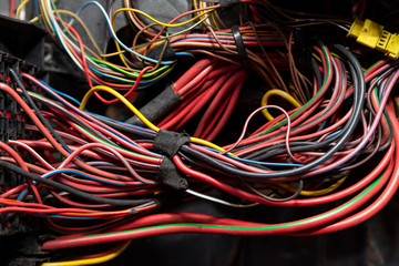 Large wide cable with multicolored red and green wires and connectors and terminals in the wiring...