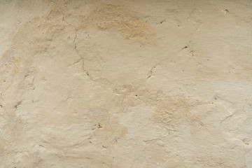 Clay wall background, fragment of an old clay wall with cracks