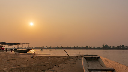 Fototapeta na wymiar A boat on a sandy beach at sunset