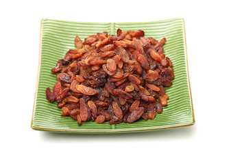 brown raisins on a white background
