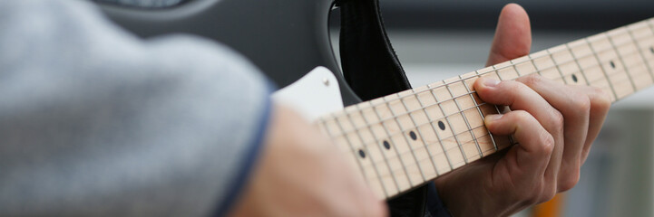 Male hands at home play and tun