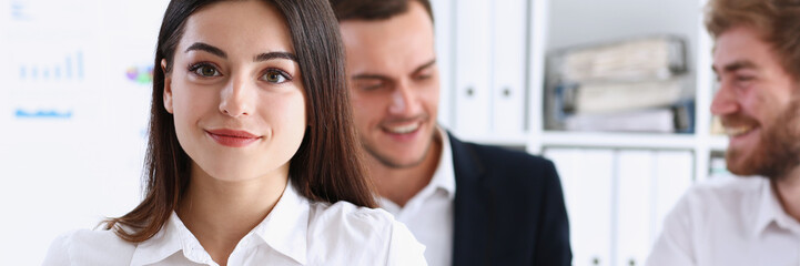 Beautiful smiling cheerful girl at workplace