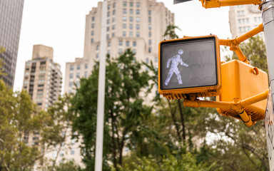 Pedestrian signal shows that people can walk across the street. Walk sign.