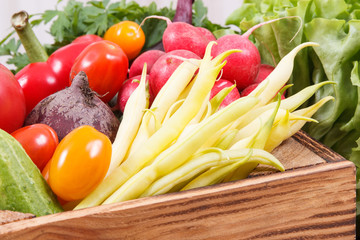 Healthy vegetables in wooden box as snack containing vitamins
