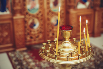 The candle flame in orthodox church, selective focus, closeup