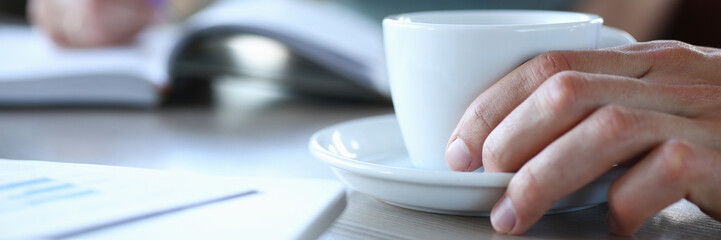 business people in cafe coffee break at table hold cup of coffee in arm