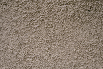 Gray-brown plaster wall. Building hair dryer to copy space