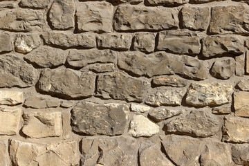 Ancient wall made of natural rocks and cement